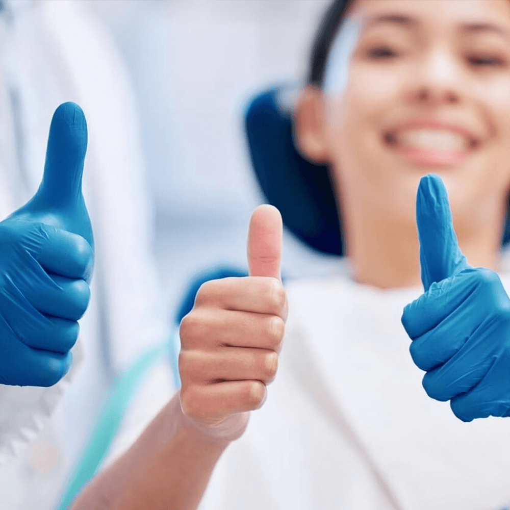 Patient with her thumbs up